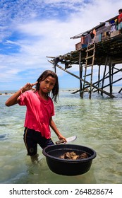 May 5 2011- Mabul Island, Malaysia - Sama-Bajau's People Hunting Sea Urchin For Family Food. They Are Are Traditionally From Islands Of The Sulu Archipelago In The Philippines.