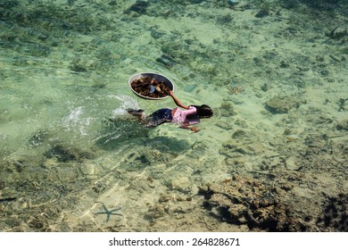 May 6 2011- Mabul Island, Malaysia - Sama-Bajau's People Hunting Sea Urchin For Family Food. They Are Are Traditionally From Islands Of The Sulu Archipelago In The Philippines.