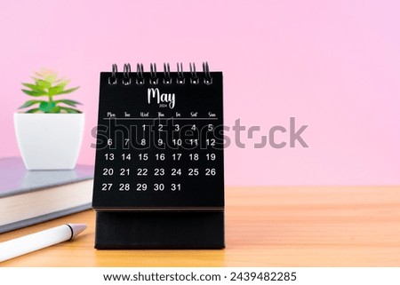 May Mini desk calendar for 2024 year on worktable with pink color background.