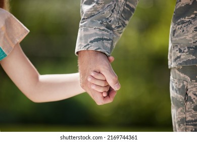 May you be surrounded by friends and family. Shot of a unrecognizable man holding his daughters hand outside. - Powered by Shutterstock