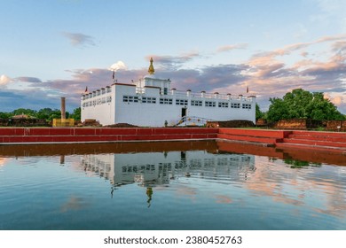Maya Devi Temple with Ashoka Pillar and it's reflection in sacred bathing pond in Lumbini, Nepal. The exact birthplace of Lord Buddha Siddhartha Gautama and one of the Eight Great Places of Buddhism.