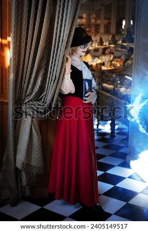 Maya school. Beautiful girl with white hair, a sorceress in a black hat casts a spell using a magic book and wand in a beautiful vintage restaurant