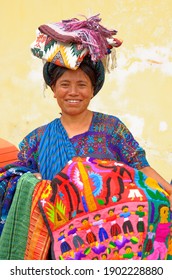 Mayan Indian woman wearing a traditional huipil sells weavings in the city of Antigua in the highlands of Guatemala - 22nd of April 2011