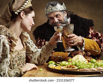 Maybe a full goblet will cheer you up mlady. A mature king feasting alone in a banquet hall. - Shutterstock ID 2151106377