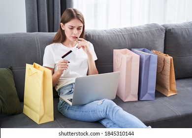 Maybe Next Time?..Gorgeous Stylish Woman Doubts About One More Purchase While Looking At The Laptop Screen During Online Shopping