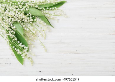 may-lily on wooden background
