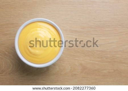Mayonnaise or mayo is a creamy sauce prepared with eggs and oil. Usually used on sandwiches, different salads, as well as fried potato, top view