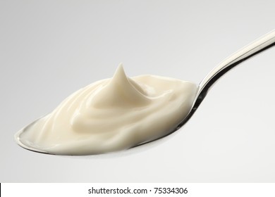 Mayonnaise On A Spoon With White Background