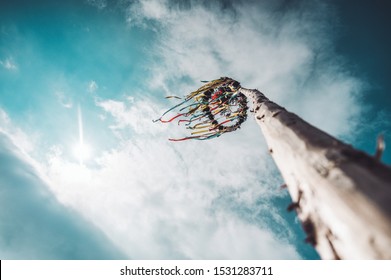 Maypole and clouds in the blue sky