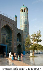 Mazar-i-Sharif, Balkh Province / Afghanistan - Aug 31 2005: A Family Leaves The Blue Mosque In Mazar I Sharif. Women Wear White Burqas (burkas) And Children Play In The Sunshine. Northern Afghanistan.