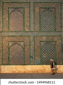 Mazar-i-Sharif, Balkh Province / Afghanistan - Aug 31 2005: A Man Walks Past The Blue Mosque In Mazar I Sharif In The Sunshine. Colorful Mosaics And Tiles Adorn The Mosque Walls. Northern Afghanistan.