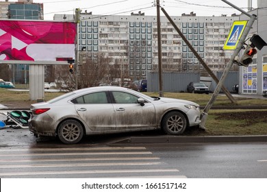 In A Mazda Car Accident, A Drunk Driver Knocked A Traffic Light At A Pedestrian Crossing And Flew Out Of The Road, A Wrecked Car And A Broken Traffic Light.