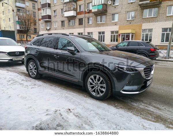 Mazda CX-9 in\
winter in the city is parked on the side of the road during the day\
against the background of brick houses on February 03, 2020 in\
Russia, Kazan, Spartakovskaya\
Street