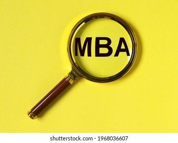 MBA Acronym Of Master Of Business Administration Degree. Education Concept. Magnifier For Learning On Yellow Background.