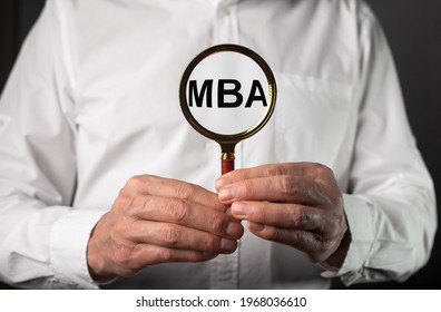 MBA Acronym Of Master Of Business Administration Degree. Education Concept. Businessman Hands With Magnifier.