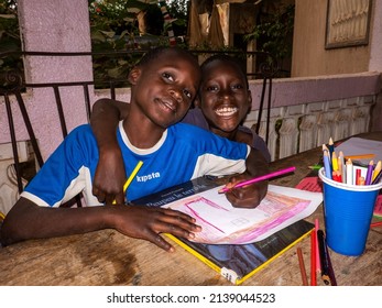 MBOUR, SENEGAL - DECEMBER Circa, 2021. Unidentified Young Child Writing Letter To Godfather Or Godmother Because European NGO Help Him To Pay School And Food For Family. Close-up On Hands