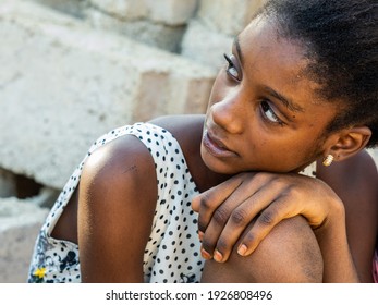 MBOUR, SENEGAL - JANUARY Circa, 2021. Portrait Of Unidentified Young Senegalese Children, Not Looking At Camera. Beautiful Skin, Hairs, Light. Outdoors