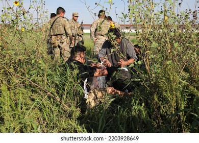 McAllen, TX, USA - Sept. 9, 2022: A Group Of Texas National Guard Soldiers Guards Five Mexican Men Who Were Apprehended After Crossing The Rio Grande River Illegally.