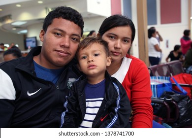 McAllen, Tx/U.S. - April 17, 2019:  A young Honduran family seeking asylum from poverty and gang violence wait at the bus station for their bus to go stay with sponsors until their hearing.