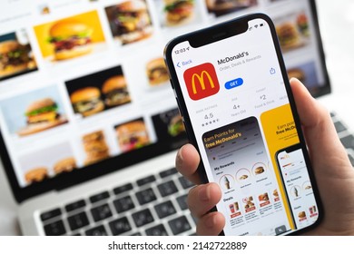 McDonalds App Icon. Hand With Mobile Phone With Application. Fast Food Concept Photo