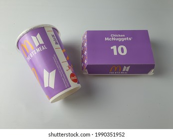McDonald's BTS meal empty packaging of paper cup and nuggets box of. Must have item for BTS Army or fans. BTS is a famous South Korea celebrity. Purple set on white background. Malaysia. June 2021