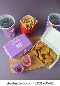McDonalds BTS meal set. BTS Bangtan Sonyeondan is a popular South Korea Boy band group. Meal set consist of 10 pieces nuggets, fries, dipping sauce and drink. Purple background. Malaysia. May 2021
