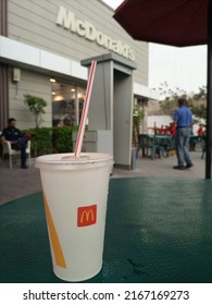 A McDonald's Drink Glass With Plastic Straw At A Mc Cafe . It Is An American Brand Franchise -Karachi Pakistan - Jun 2022 