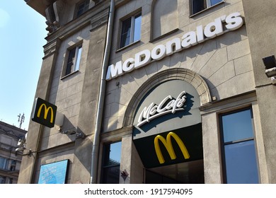 McDonald's Fast Food Restaurant. McCafe Logo On The Building Of The McDonalds World's Leading Global Foodservice Retailer. Dessert Center,  McDelivery Service, Restaurant​ Service. Minsk, Belarus 