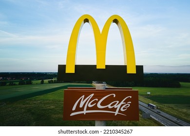 McDonalds Logo With McCafe Sign Near Highway, Aerial View. McDonald's Restaurant Biggest Fast Food Company In World. Katy Wroclawskie, Poland - June 17, 2022