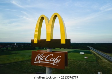 McDonalds Logo With McCafe Sign Near Highway, Aerial View. McDonald's Restaurant Biggest Fast Food Company In World. Katy Wroclawskie, Poland - June 17, 2022