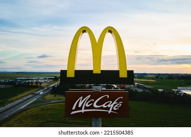 McDonalds Logo With McCafe Sign Near Highway, Aerial View. McDonald's Restaurant Biggest Fast Food Company In World. Katy Wroclawskie, Poland - June 17, 2022