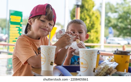 McDonald's In Poland - Nowy Sacz - August 18, 2022. Joyful Brothers Eat In Their Favorite Restaurant. Shallow Depth Of Field.