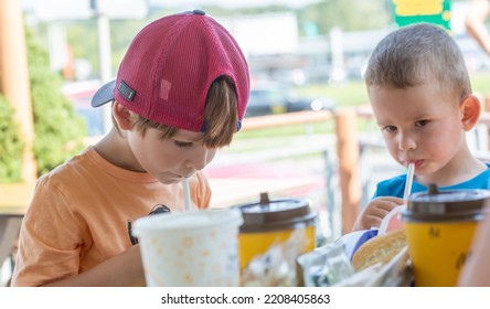 McDonald's In Poland - Nowy Sacz - August 18, 2022. Joyful Brothers Eat In Their Favorite Restaurant. Shallow Depth Of Field.