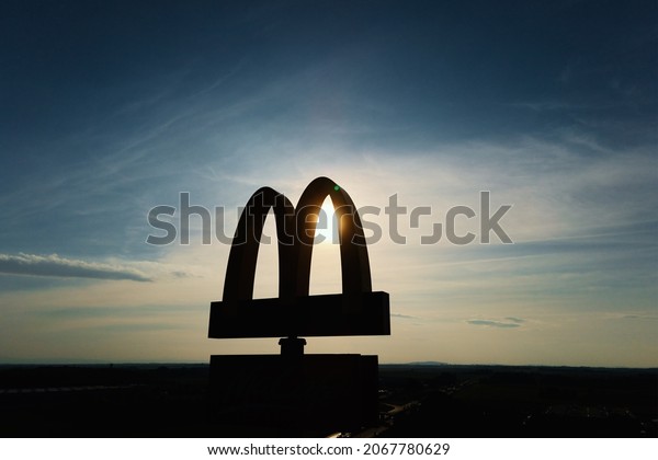 McDonald\'s\
restaurant logo, aerial view. McCafe sign silhouette. Katy\
Wroclawskie, Poland - October 2,\
2021