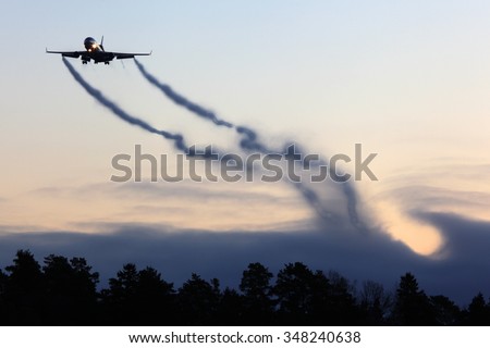 Mcdonnell Douglas MD-11F civil cargo airplane landing with vortexes coming from wingtips.