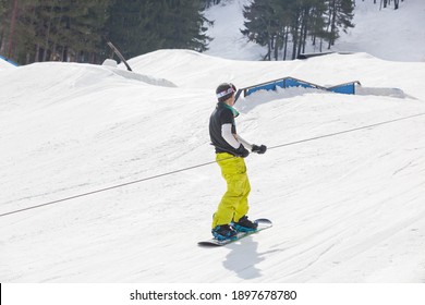 MCHENRY, MD, UNITED STATES - Feb 24, 2013: Snowboarder riding a rope tow at the Wisp Resort in Maryland 