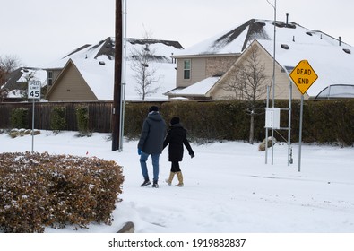 Mckinney, TX USA - February 17, 2021: Street view of Texan walking on the road after snowstorm