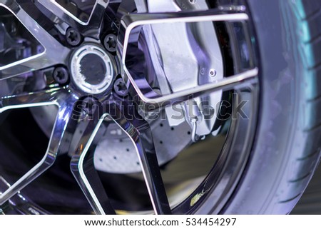 McQueen's wheels, black, silver in soft light.