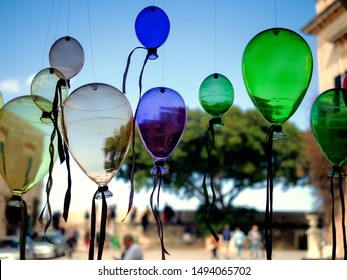 Mdina, Malta: Traditional Maltese souvenirs - colored glass balloons against a blue sky