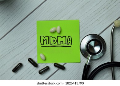 MDMA Write On Sticky Notes Isolated On Office Desk. Healthcare Or Medical Concept. Selective Focus On  Capsule And Stethoscope