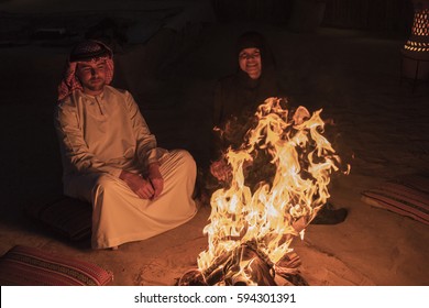 Me and my wife by the campfire by the desert safari camp, Dubai February 2017,happy healthy attractive smiling couple by the campfire in the duba desert with traditional clothes