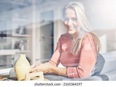 Me Time, Now Thats More Like It. Portrait Of An Attractive Mature Woman Relaxing On The Sofa At Home.