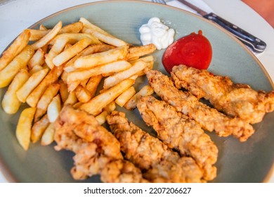 Meal In Dominican Republic. French Fries With Pechurina (chicken Strips)