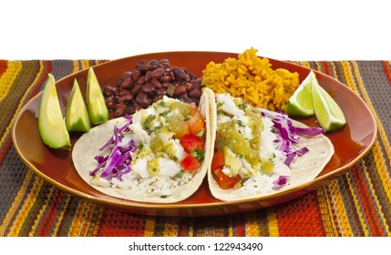 A Meal Of Fish Tacos With Black Beans And Mexican Rice.