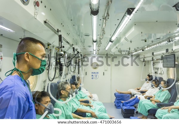 MEAL NURSE TAKE CARE\
PATIENT, THAILAND - AUGUST 18,2016 : meal nurse take care patient\
in hyperbaric chamber at Navy hospital Bangkok,Thailand , August\
18, 2016