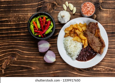 Meal On White Plate, Rice, Beans, Steak And Chips, Wooden Background