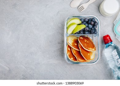 Meal Prep Containers With Pancakes, Blueberry And Apple. Breakfast In Lunch Box. Top View, Copy Space.