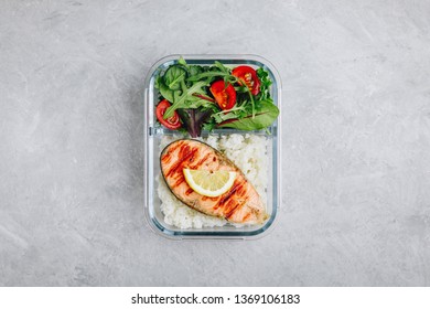 Meal Prep Containers With Salmon And Rice, Green Mix Salad With Tomatoes. Top View, Copy Space