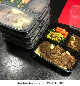 Meal Preparation In Black Containers With Roast Beef, Mashed Potatoes, Corn,  Carrots, Mushrooms And Gravy Stacked Up For The Week.