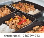 Meal prepping containers with chicken stir fry and rice 